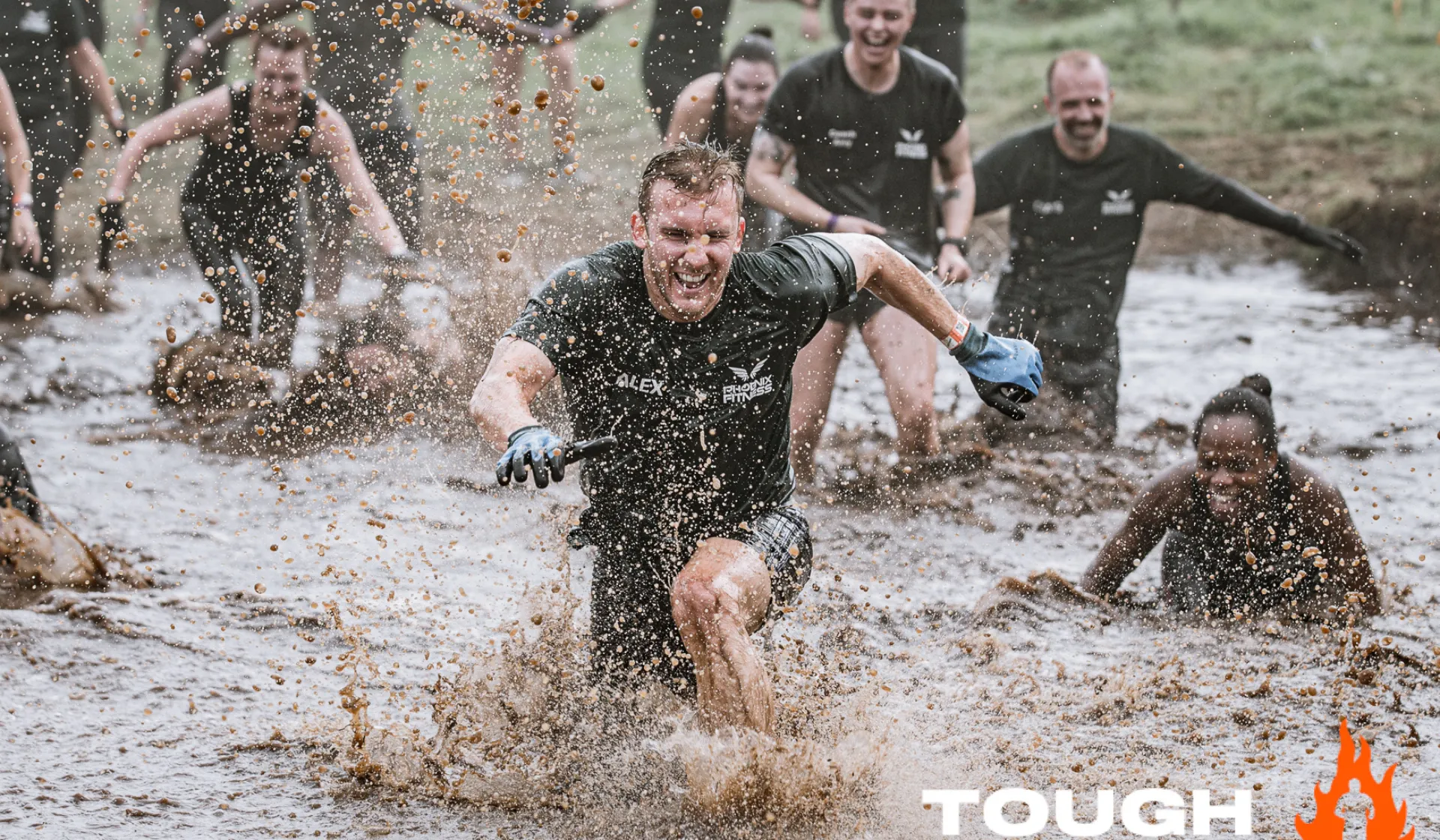 A man running through mud at Tough Mudder