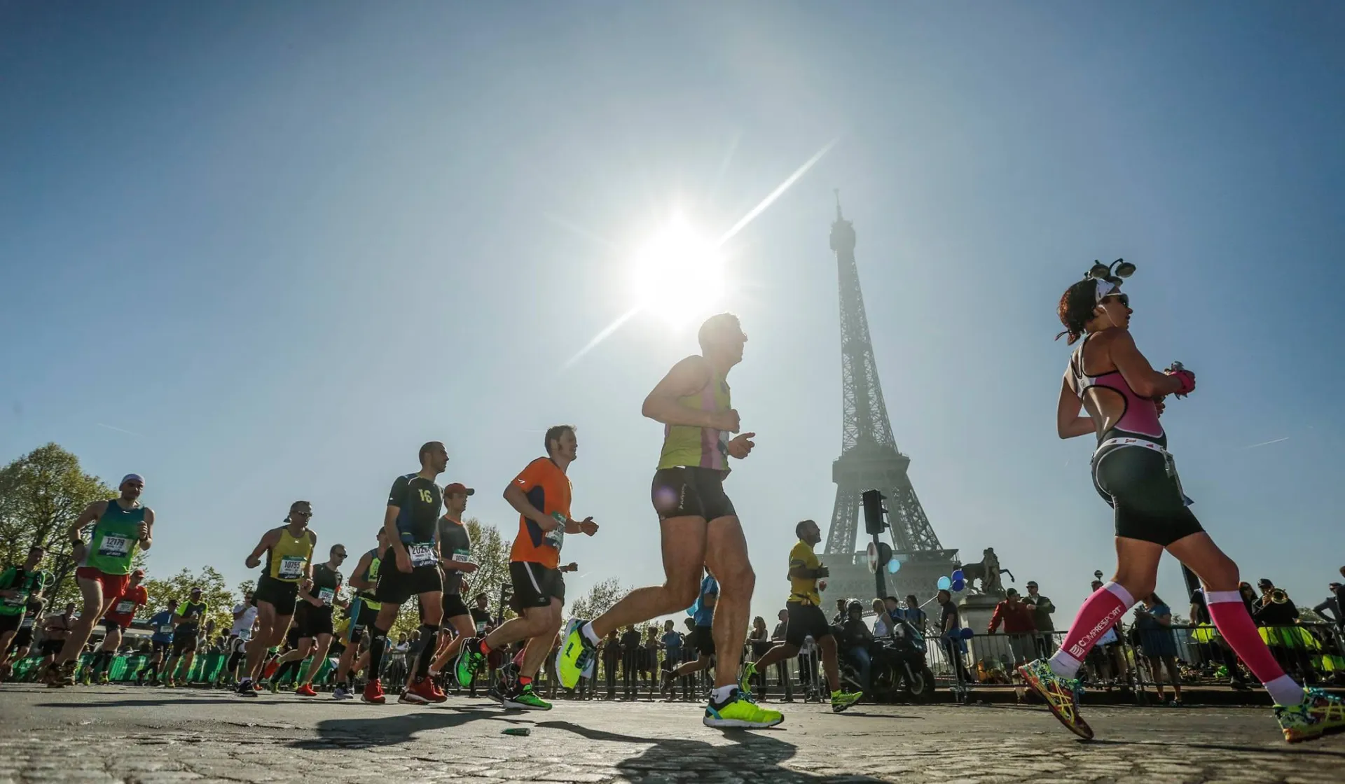 Runners pass the Eiffel Tower