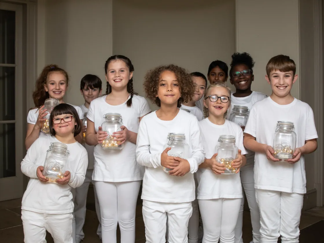 Children holding jars of light