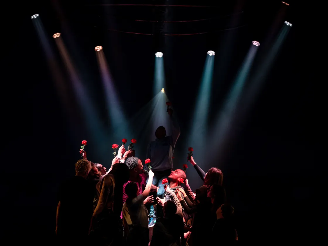 Performance of people holding flowers to the sky