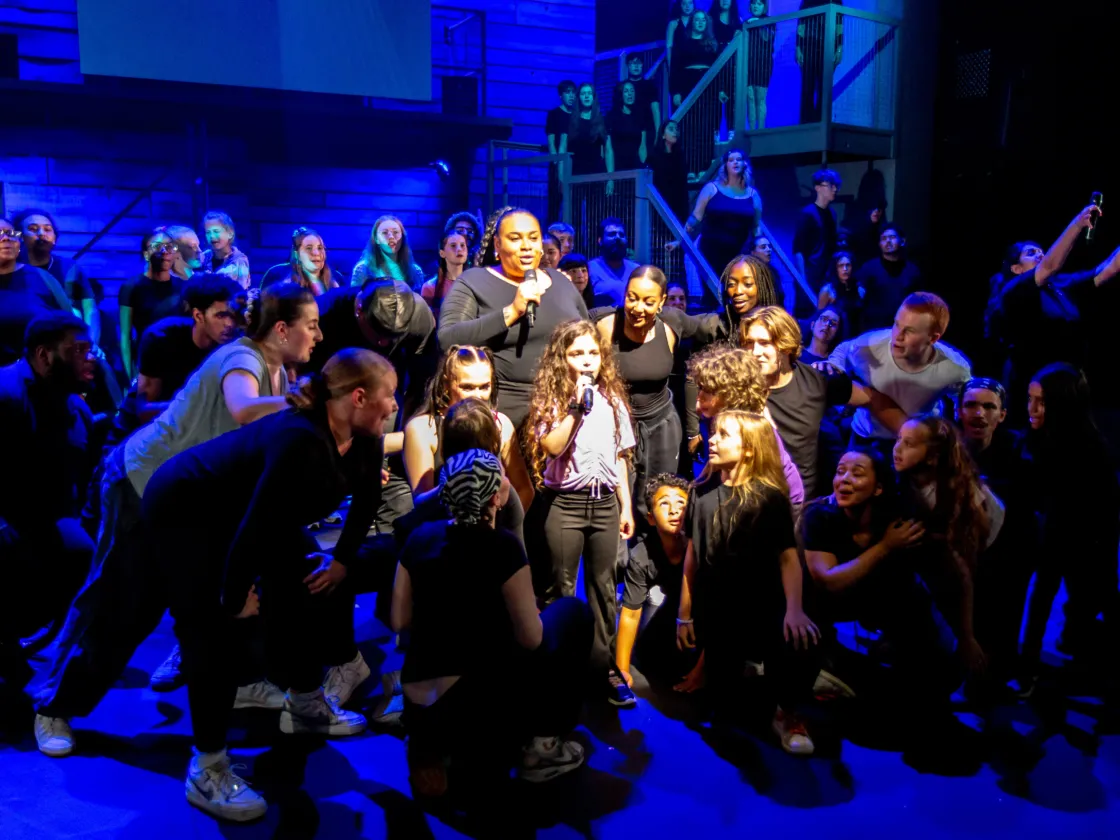 Bella singing  in we are chickenshed