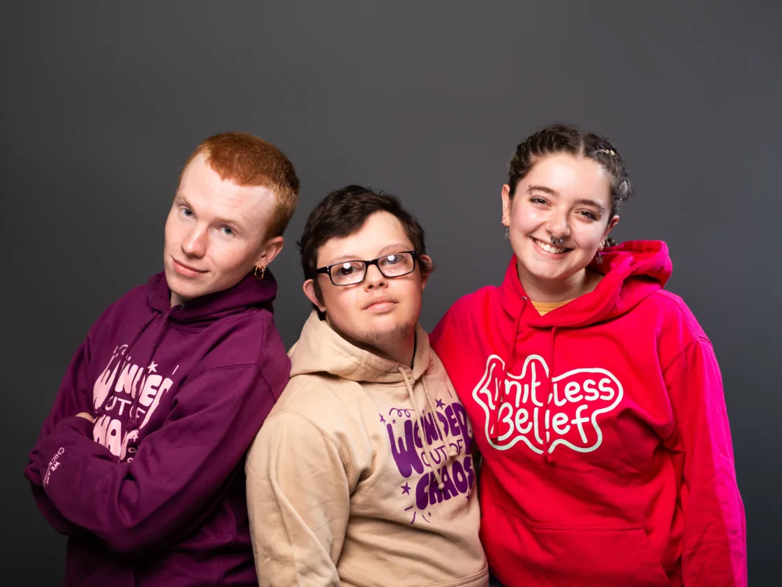 3 people wear chickenshed hoodies