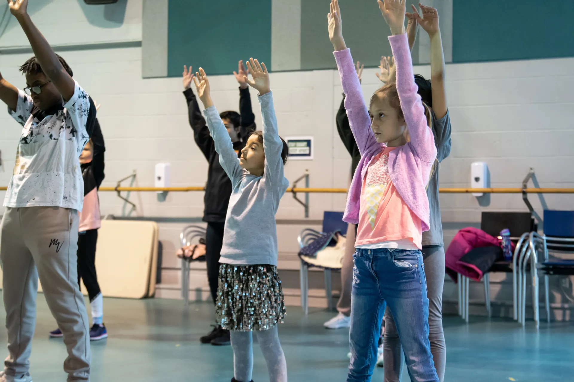 children dancing with their hands up