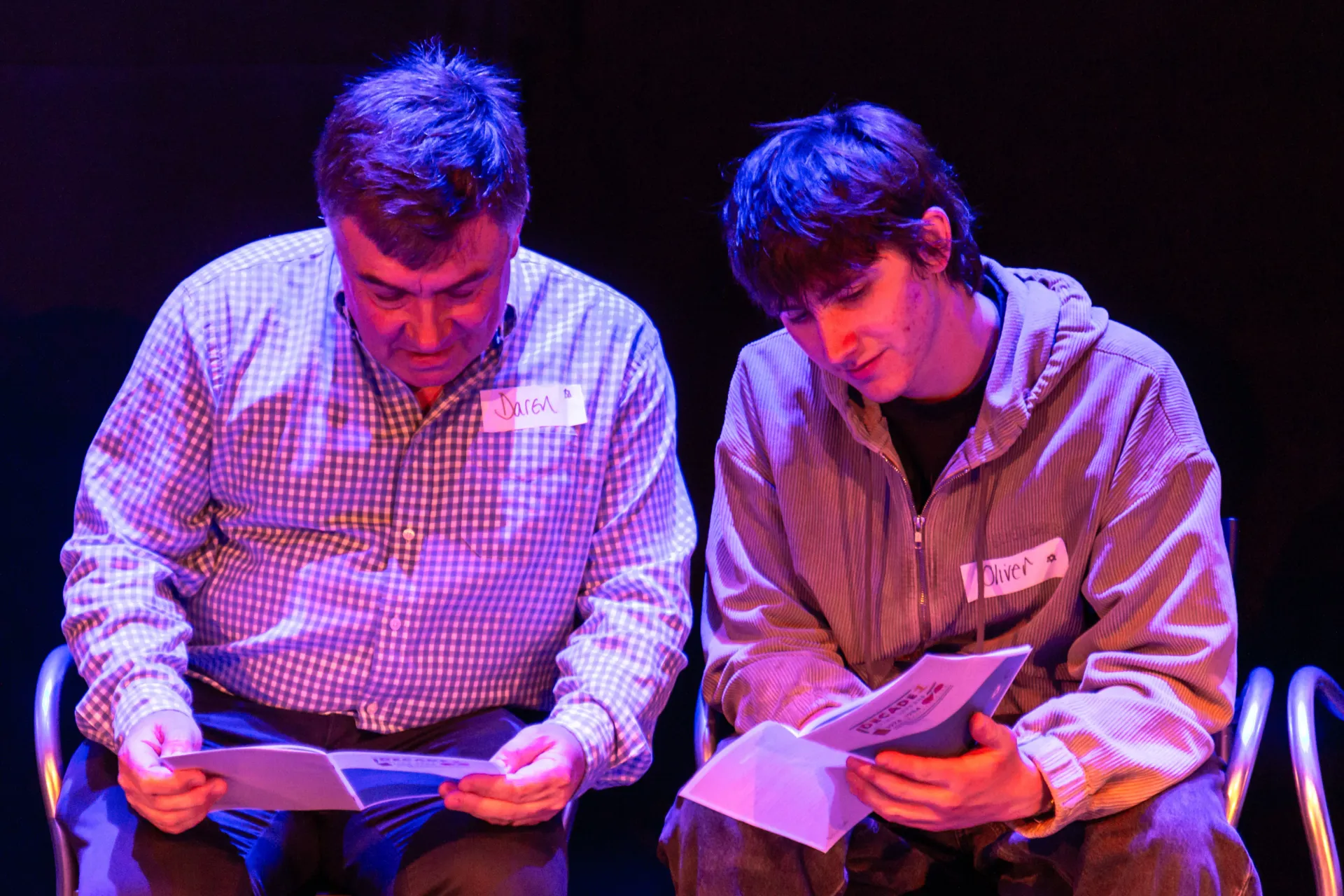 two men sharing letters