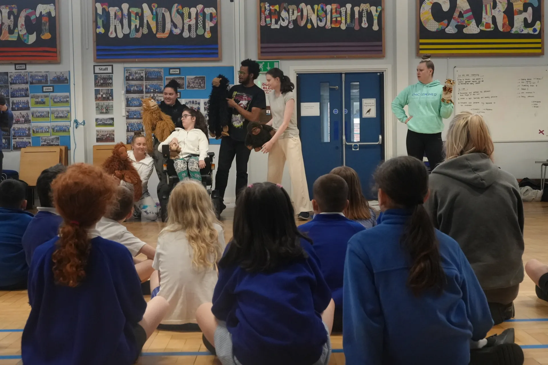 6 foundation degree students with monkey puppets performing to the children at Livingstone during the workshop