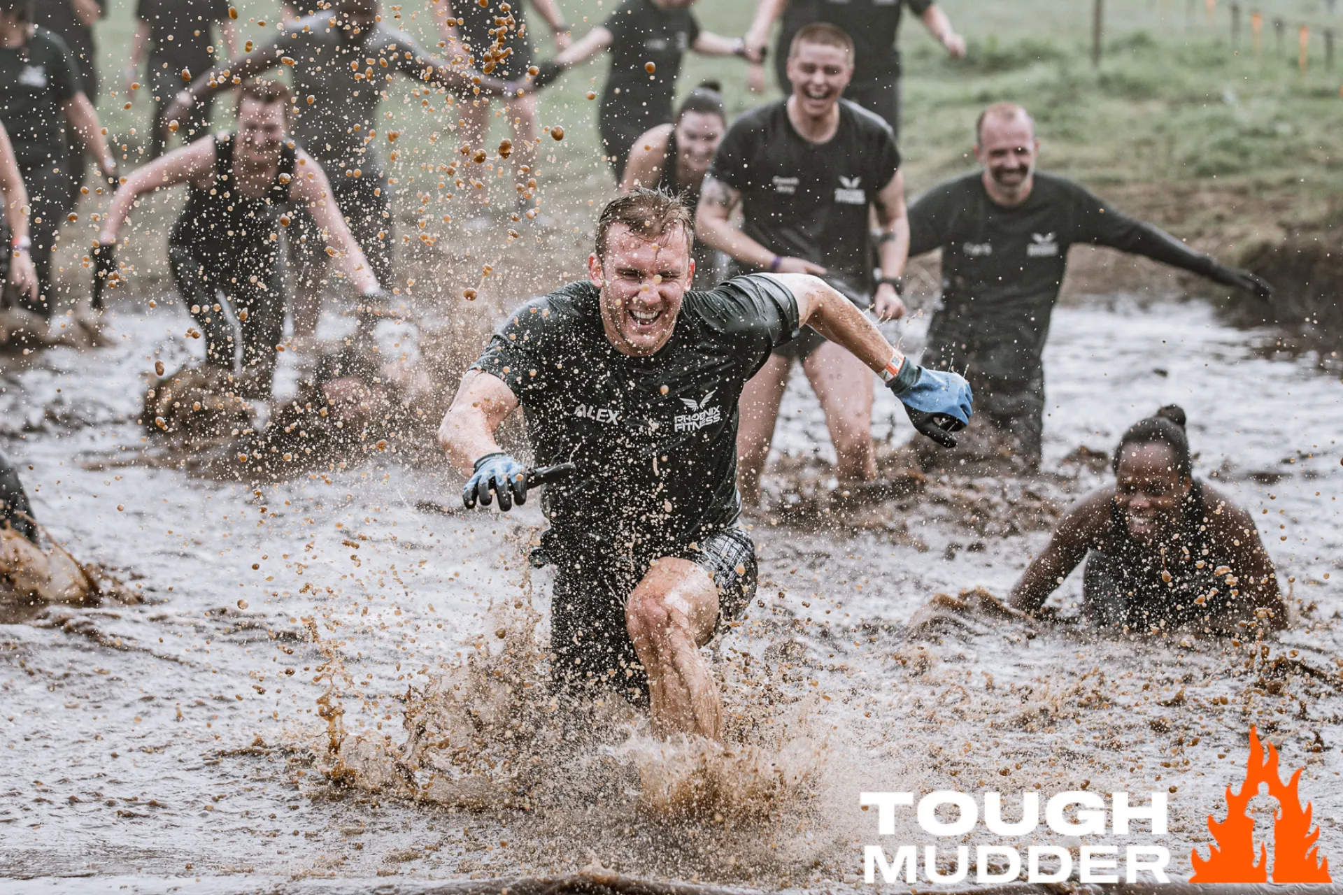 A man running through mud at Tough Mudder