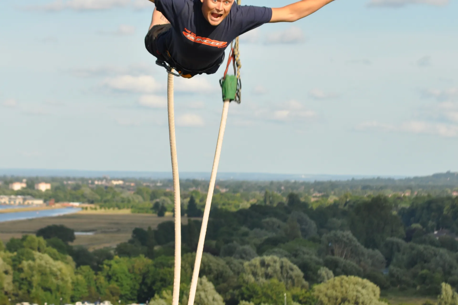 a person leapnig from a platform in a bungee jump