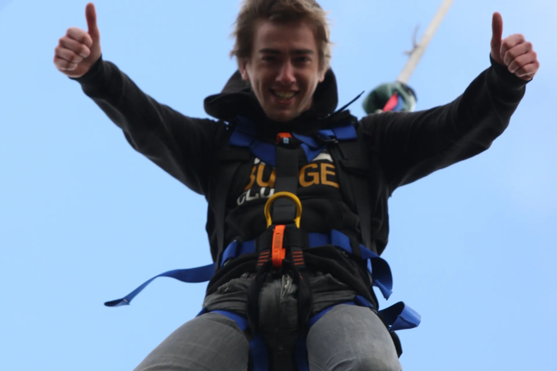 a person gives a thumbs up after completing a bungee jump