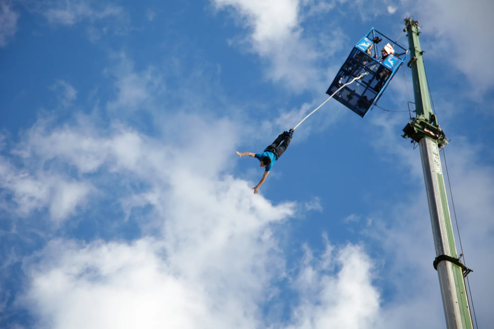a person leaps through the air in a bungee jump