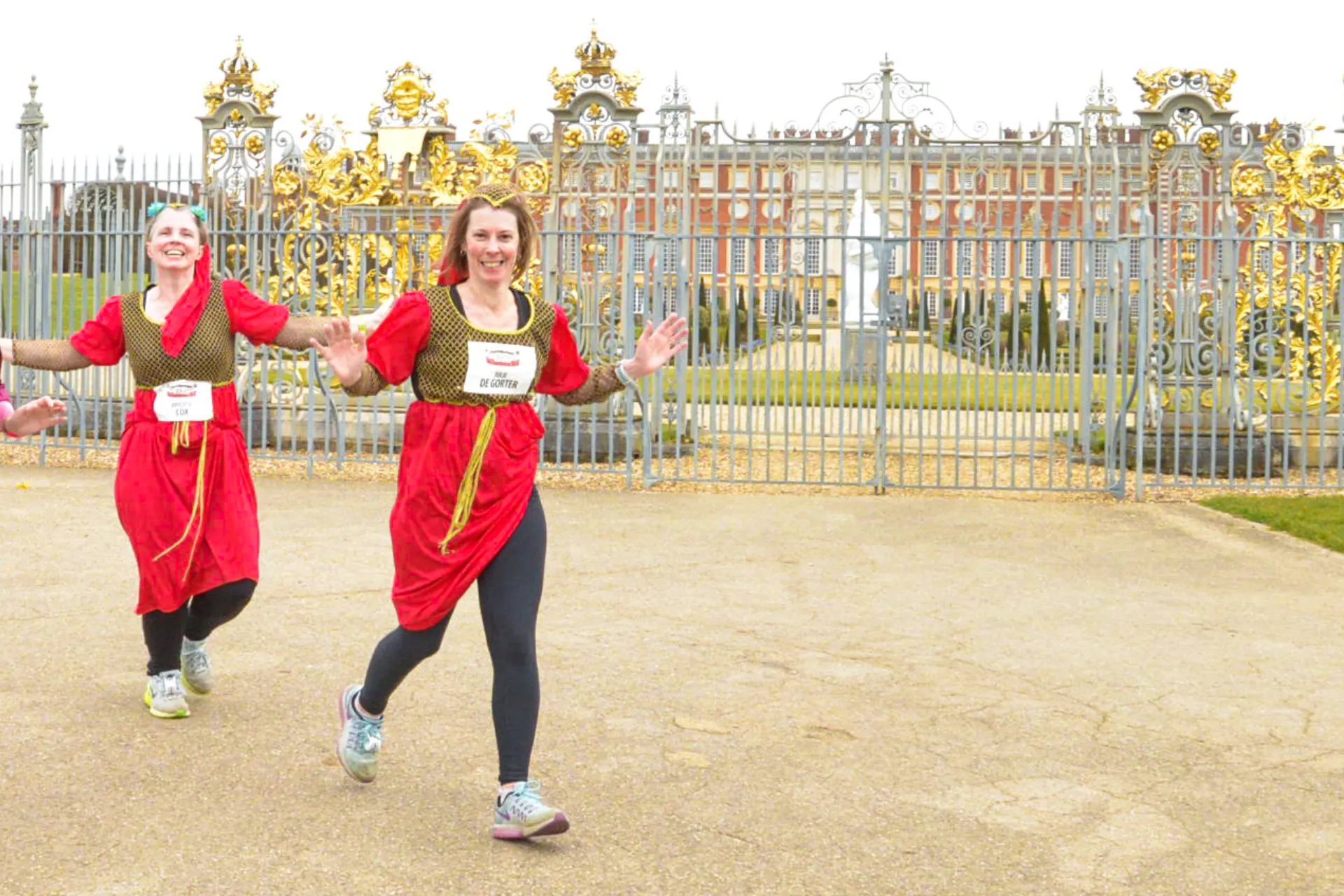 three runners in costume at Hampton Court Palace