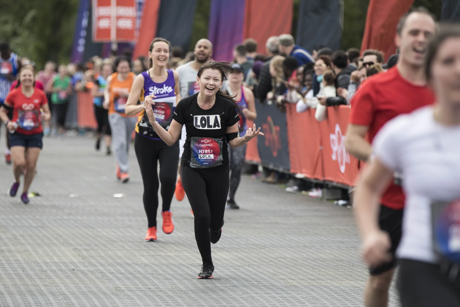 A runner cheers at the Hackney Half Marathon