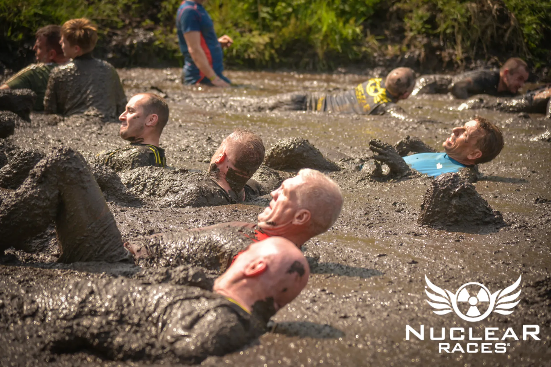 Runners slide through the mud at a Nuclear Races event
