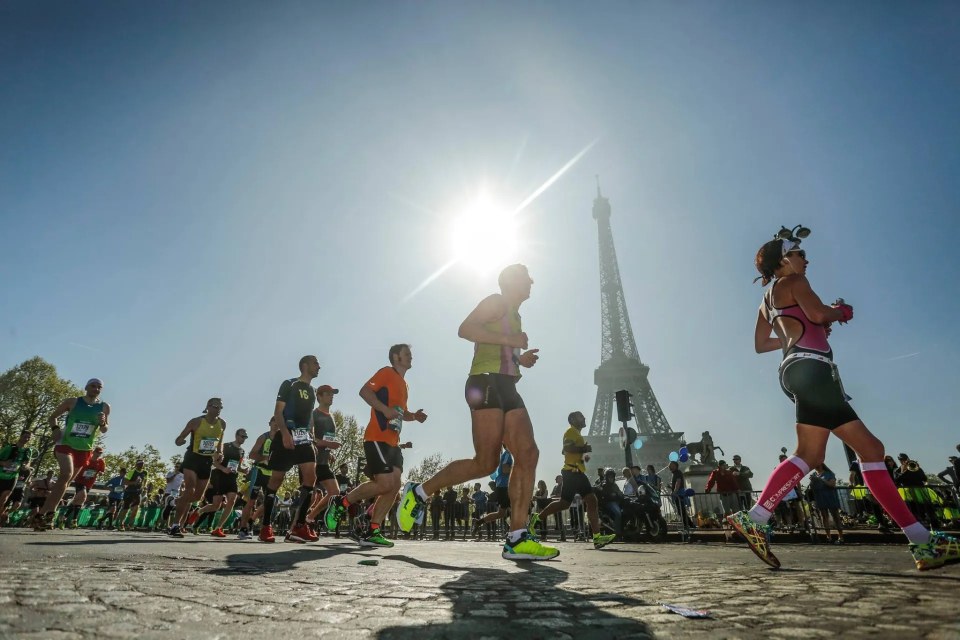 Runners pass the Eiffel Tower during the Paris Marathon