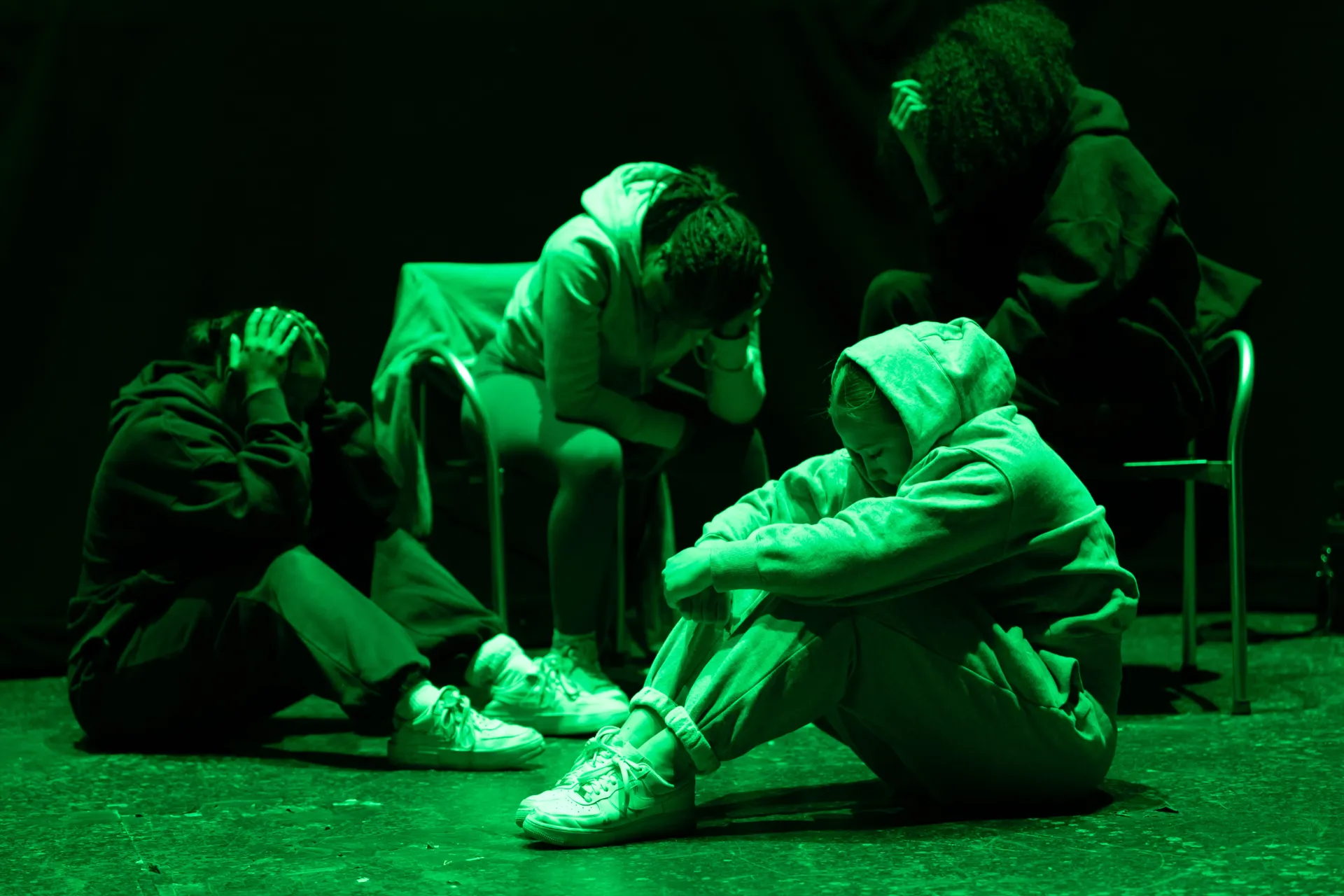 group holding themselves all looking sad and scared.